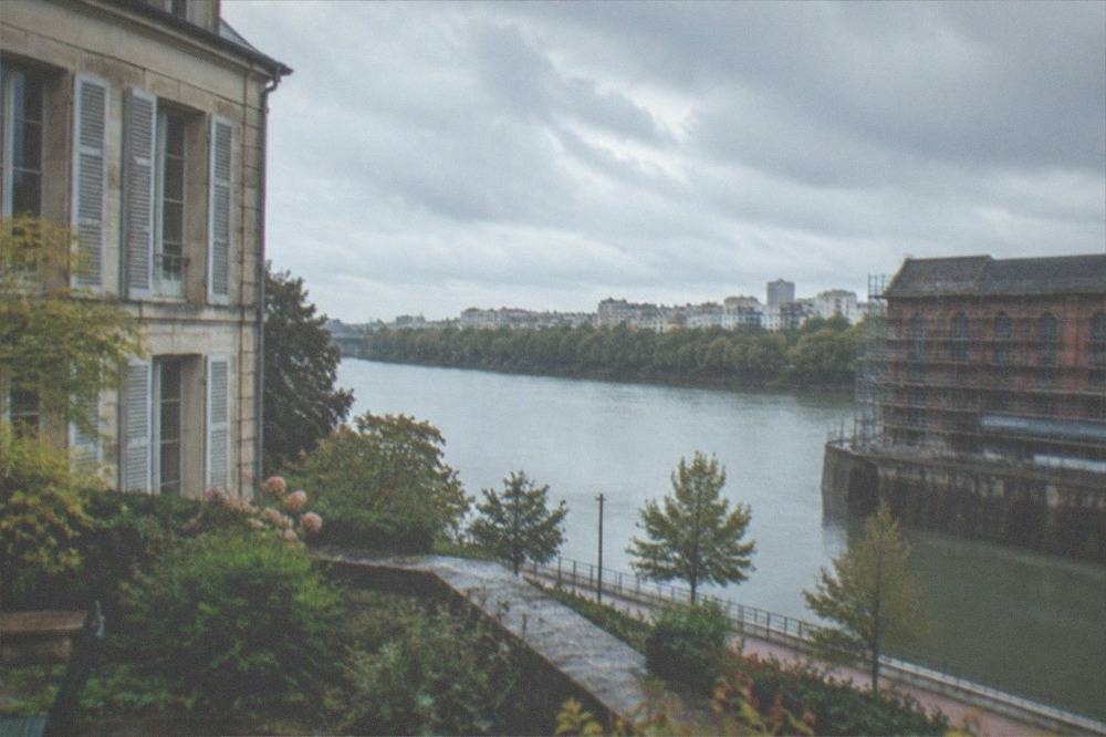 Old industrial brick building on a Loire riverbank with scaffolding around it