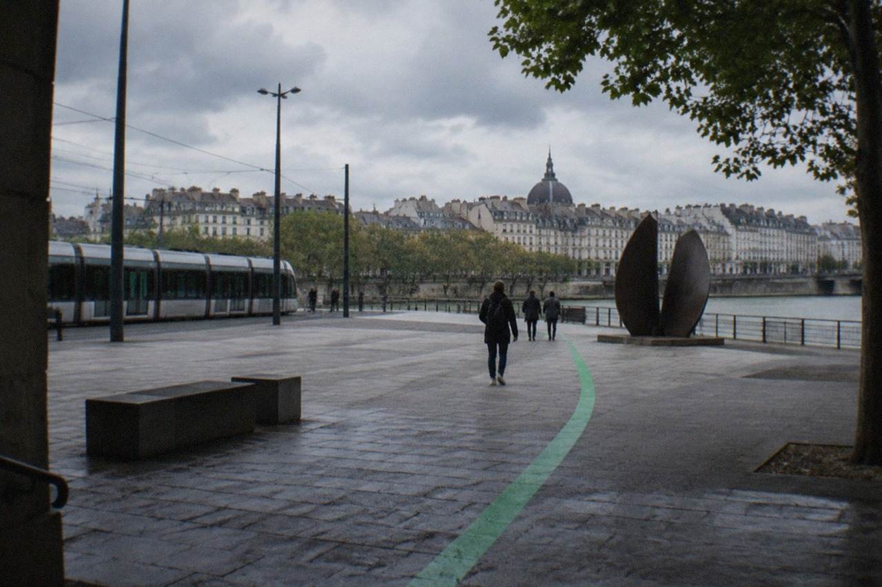 A painted green line on a Nantes pavement leading visitors towards an artwork