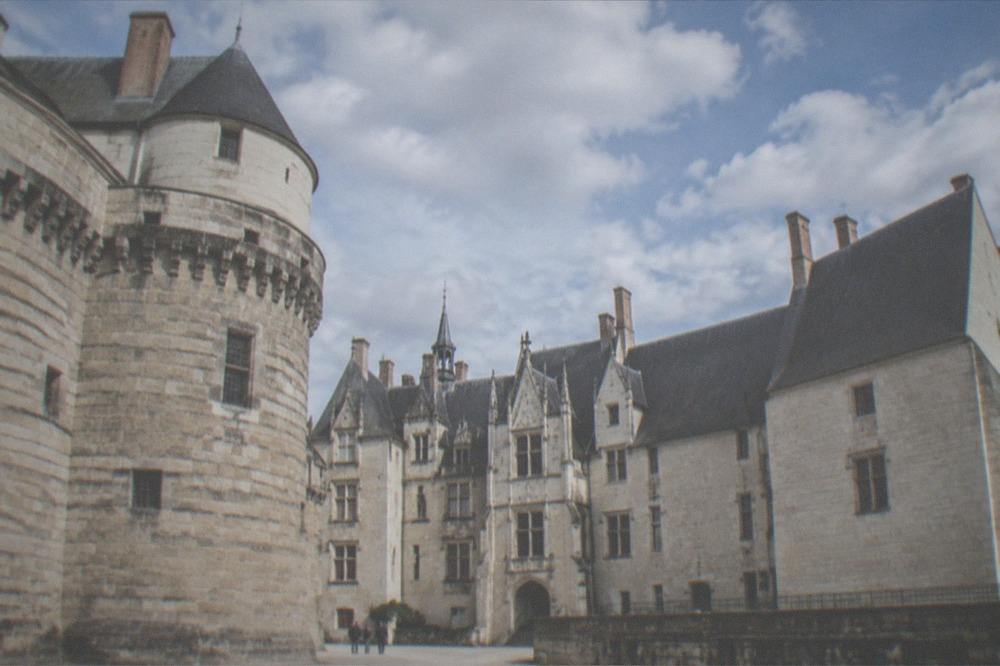 The ramparts and courtyard of the Chateau des ducs de Bretagne under a blue sky