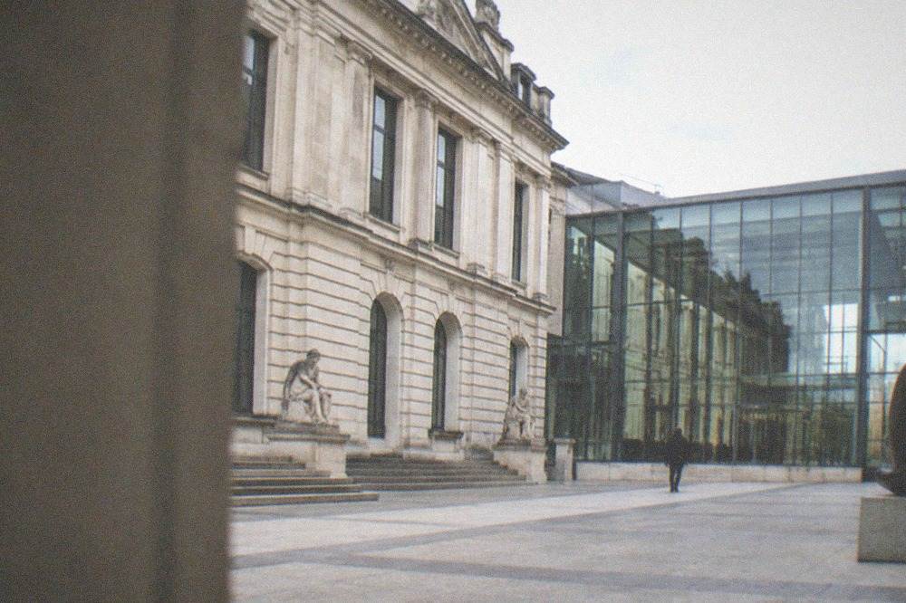 Sculptures and framed paintings displayed in a bright fine arts museum hall