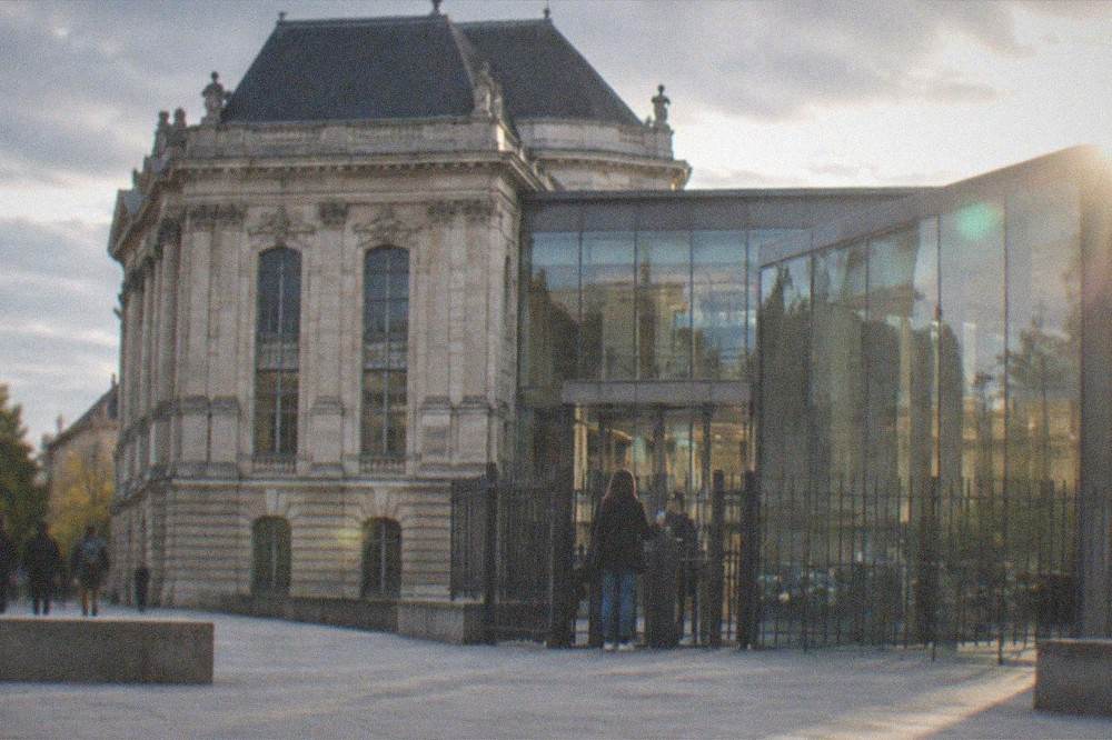 A visitor holding a city pass card at the entrance gate of a castle museum