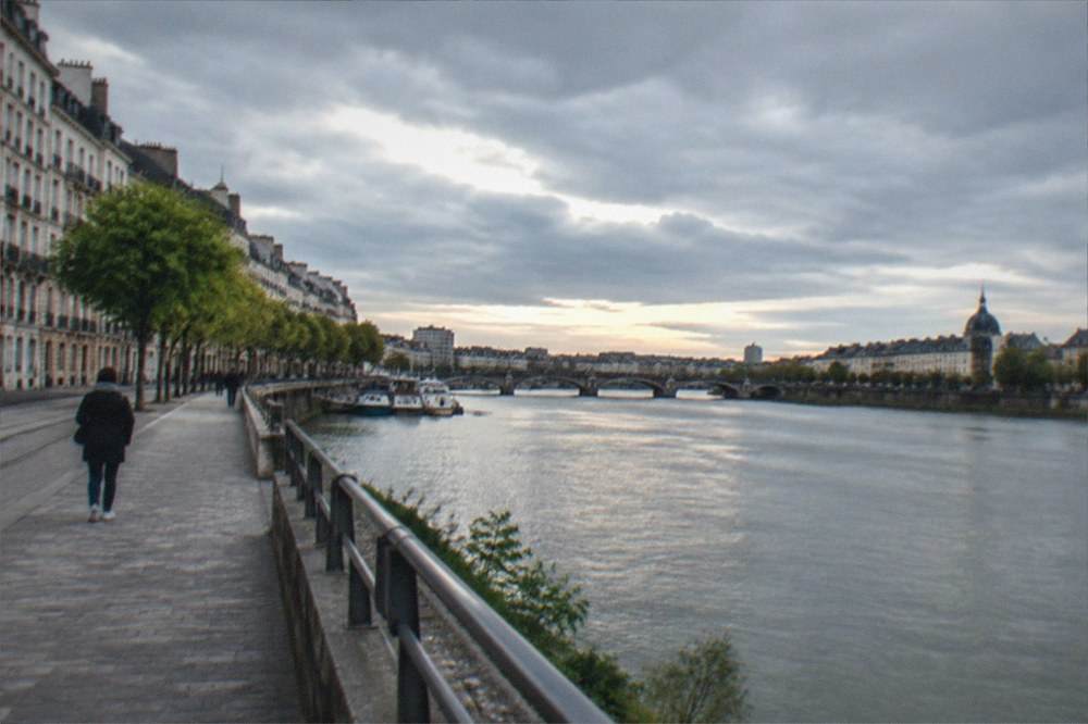 The wide Loire river flowing past the quays of Nantes at dusk
