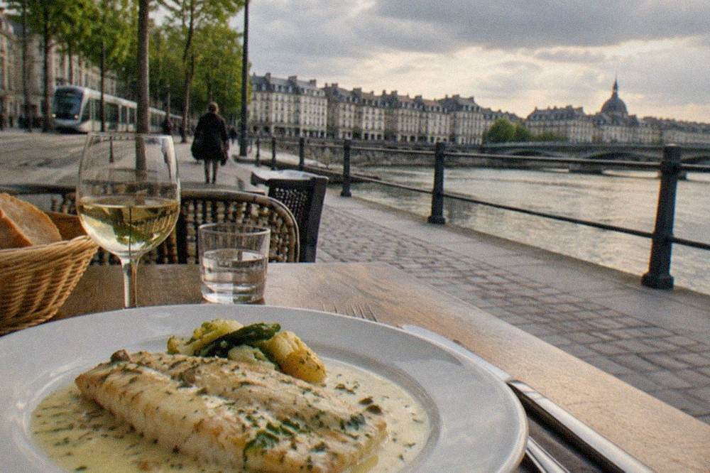 A plated fillet of river fish covered in pale butter sauce at a Nantes bistro