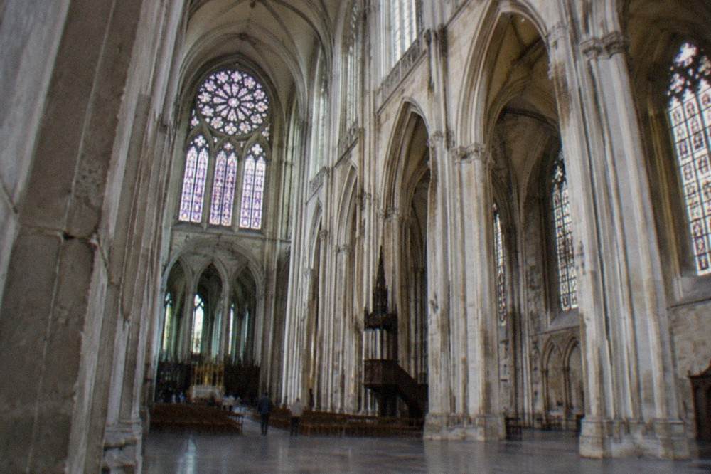 The gothic nave and stone columns of Nantes cathedral seen from the entrance