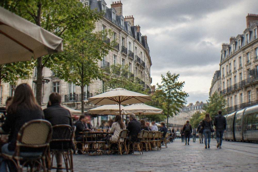 Crowded café terrace on a pedestrianised street in central Nantes in the evening