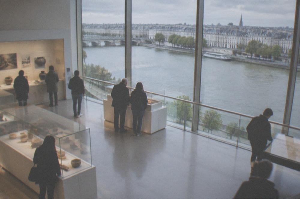 Visitors viewing displays inside a bright modern history museum gallery in Nantes