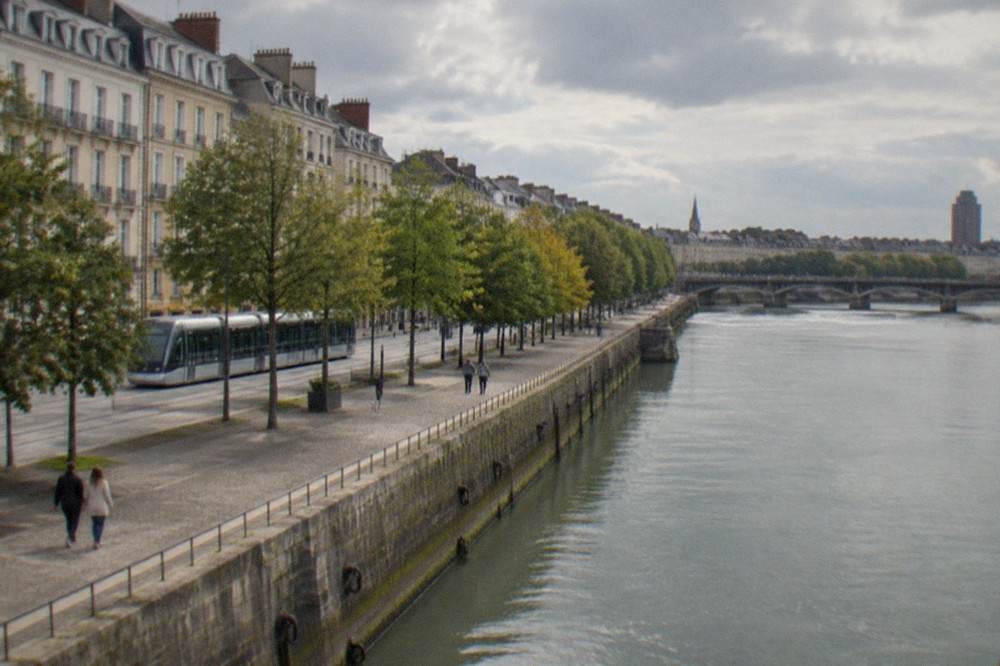 The old stone quay of the Loire in Nantes at dusk with mooring rings along the wall