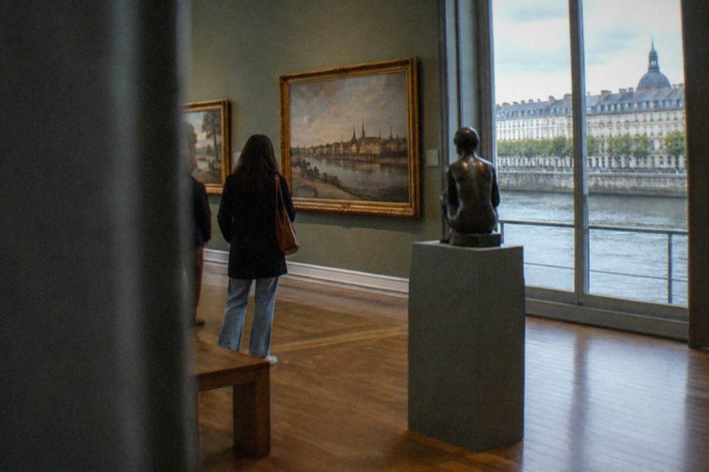 A museum gallery with historical maps and display cases about the Atlantic port of Nantes