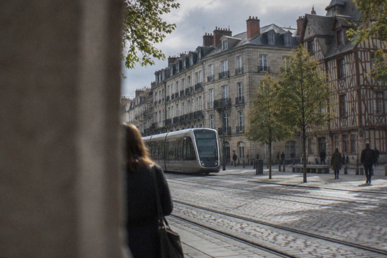Half-timbered houses and a modern tram on a Nantes street