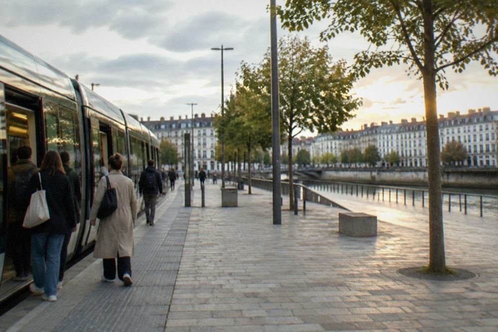 Passengers boarding a Nantes tram beside a modern square