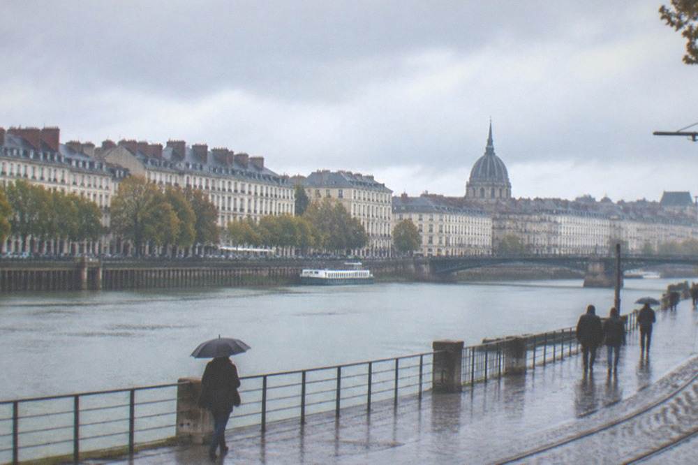 The Loire river running high past the quays of Nantes under grey skies