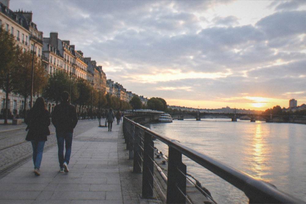 Evening light on the quays of Nantes with people walking beside the river