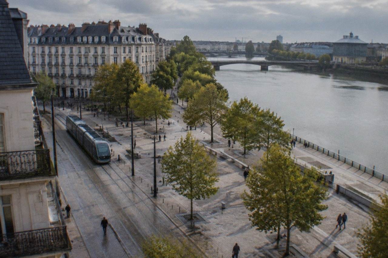 A large contemporary mural covering the side wall of a city building in Nantes