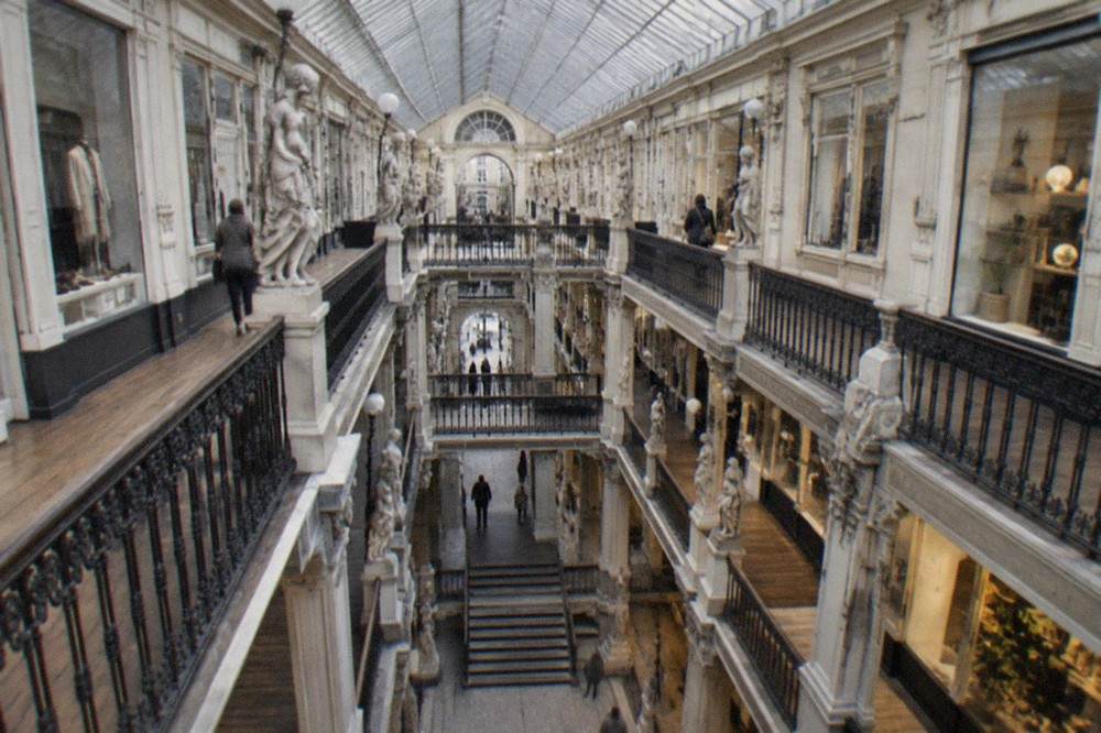 The sloped glass roof and boutique facades of the Passage Pommeraye shopping arcade