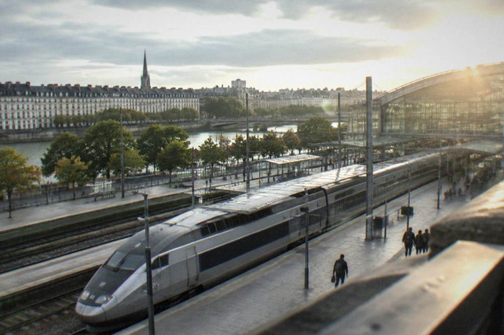 A high-speed train at a French railway platform beside a station concourse with departure boards