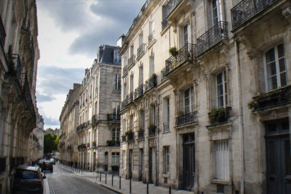 Tall stone merchant facades and wrought-iron balconies on the Île Feydeau in Nantes