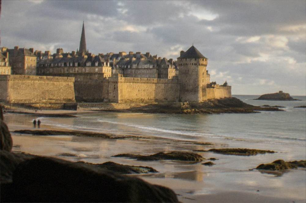 The granite walls and towers of Saint-Malo old town seen from the beach at low tide