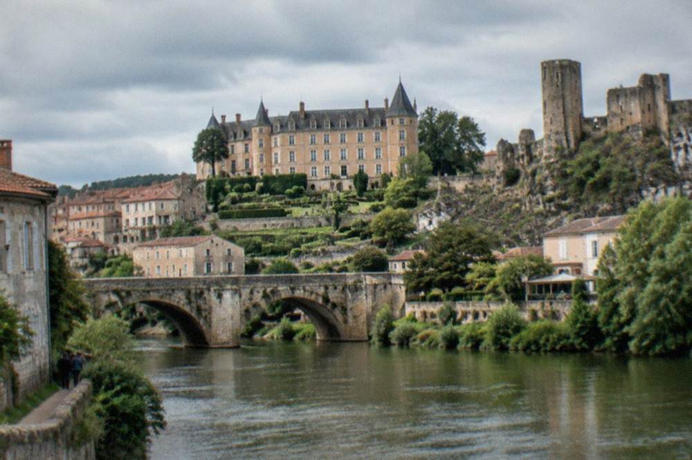 The Italianate château of Clisson above gardens and a stone bridge
