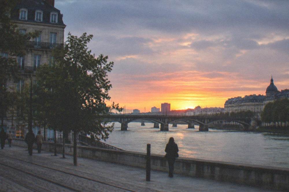 Sunset over the Loire with the bridges of Nantes silhouetted against an orange sky