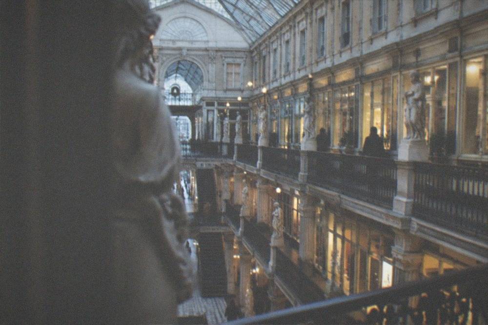 Glass-roofed interior of the Passage Pommeraye gallery with shops on several levels