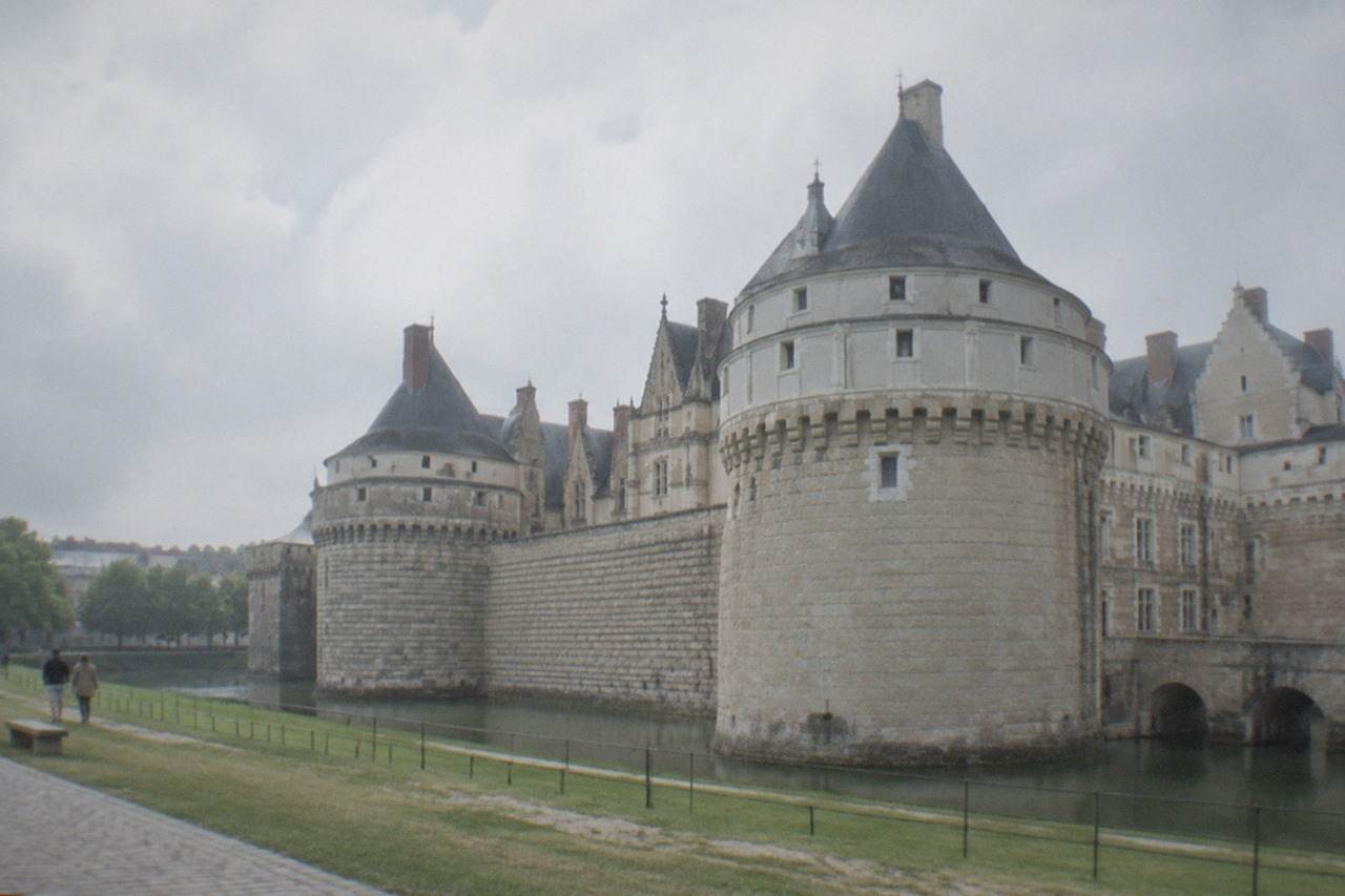 The stone towers and ramparts of the Château des ducs de Bretagne in Nantes under a daytime sky