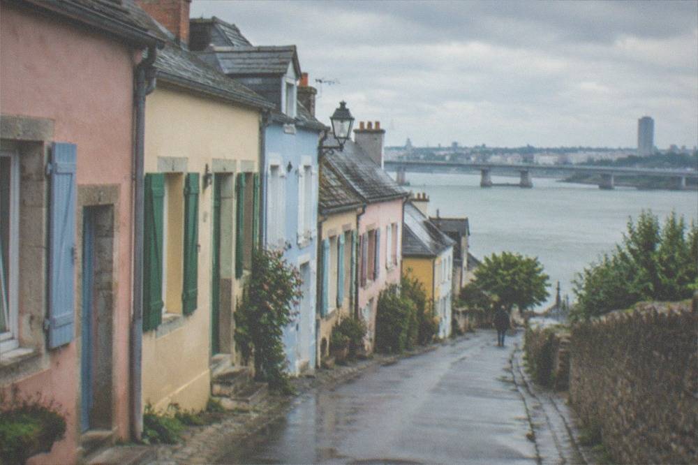 Pastel-coloured fishermen's houses along a narrow street in Trentemoult across the Loire from Nantes