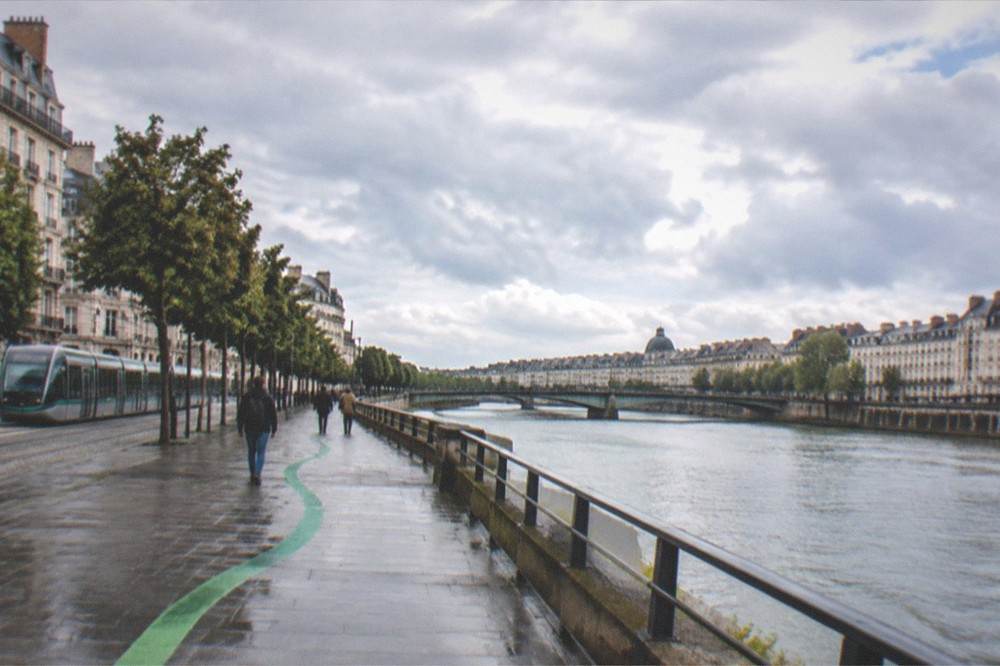 The green painted line of the Voyage a Nantes route on a Nantes pavement