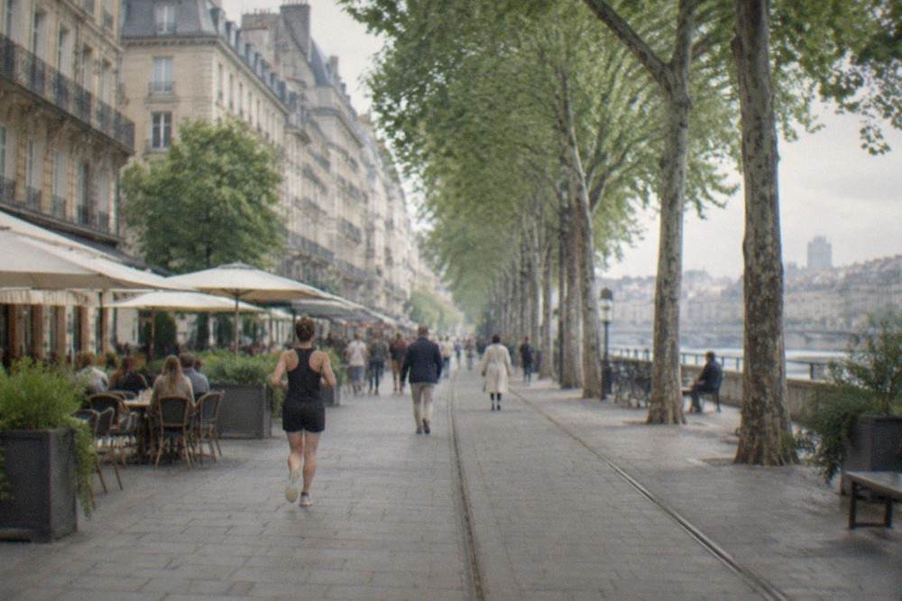 A pedestrian street in central Nantes with cafés and shoppers under plane trees